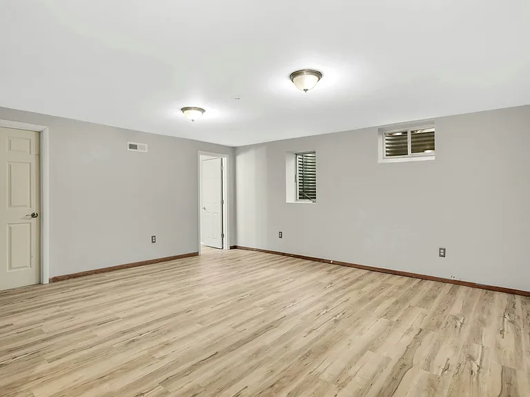 Large lower-level private suite with egress window ideal as 4th bedroom, guest space, or second living area