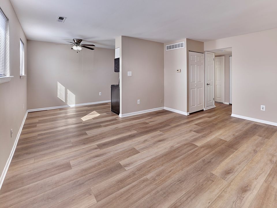 Modern open-concept living and dining space with stylish plank flooring at Village Square.