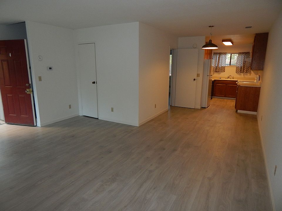 From this view, you can see how the living room transitions smoothly into the kitchen. A small hallway leads to other areas of the unit, and the overall layout is ideal for hosting or relaxing at home.