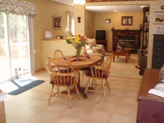 View from kitchen into Family Room with woodburning fireplace.
