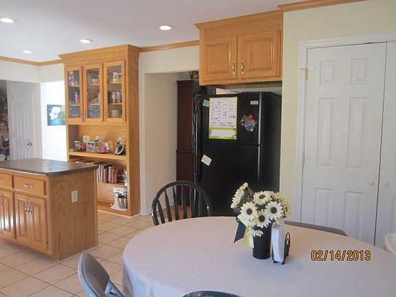 Kitchen has room for kitchen table, a large pantry, exits to garage and more