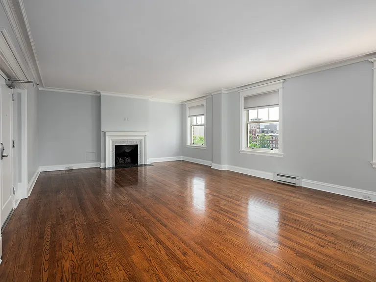 York House large living room with oak hardwood flooring, gas fireplace and crown molding.