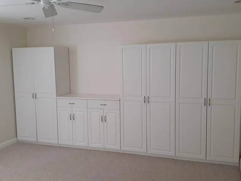 Wall to wall storage in living room.