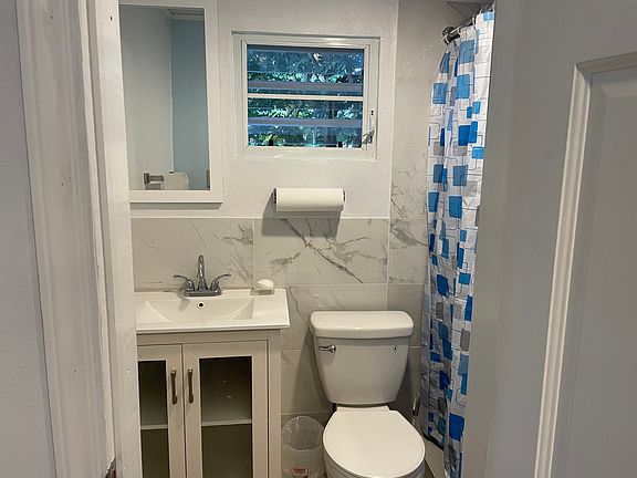 Complete bathroom with vanity and full-sized shower.