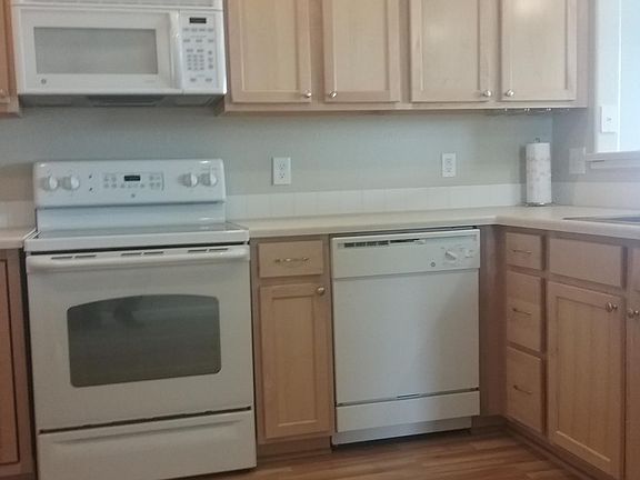 Updated kitchen with 42" cabinets, engineered-hardwood floor, newer appliances & kitchen sink.