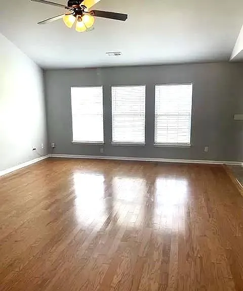 Living area - windows overlook beautiful pond. Extremely spacious and open to kitchen & dining area