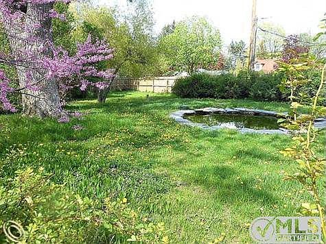 FENCED YARD WITH POND