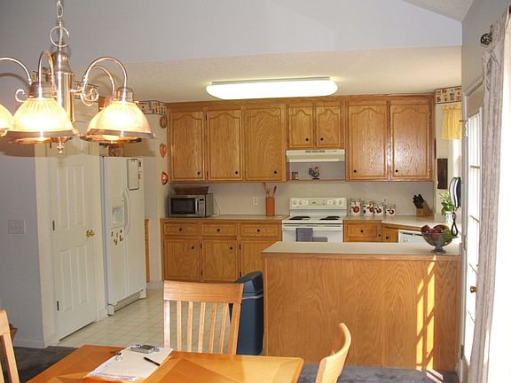 Open kitchen with breakfast bar and pantry overlooking dining room