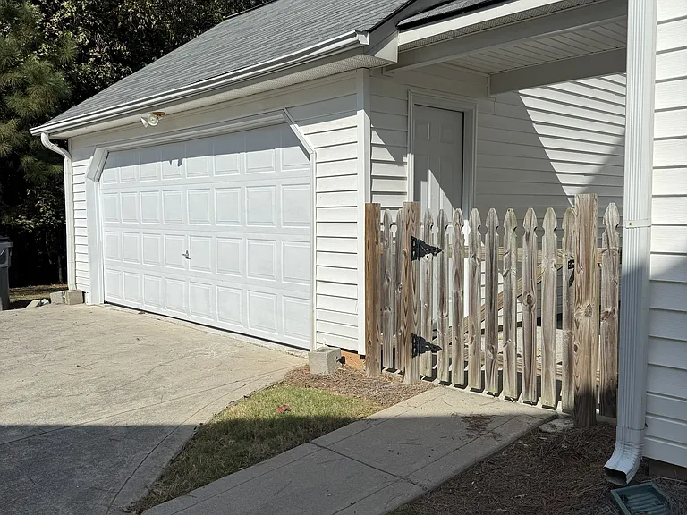 Garage and fenced-in backyard