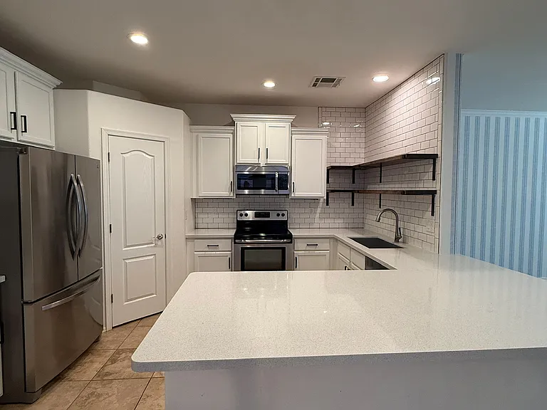 Fully updated kitchen with modern finishes and ample storage.