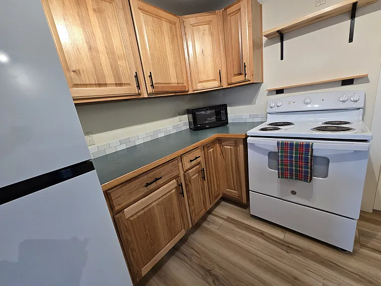 A pantry to the right of the stove isn't shown. Microwave is optional.