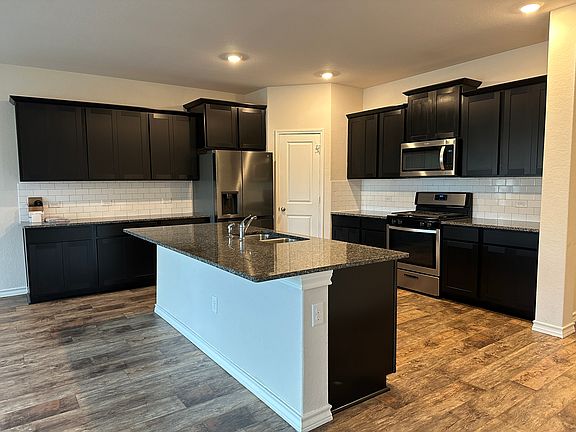 Spacious Kitchen with large pantry. Dishwasher, range, built-in microwave oven, double sink.