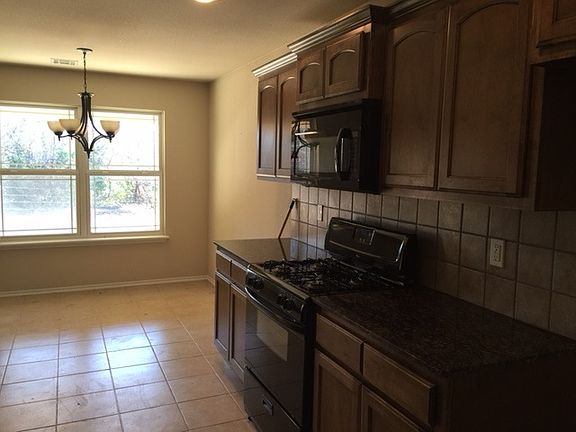 lots of cabinets and granite countertops