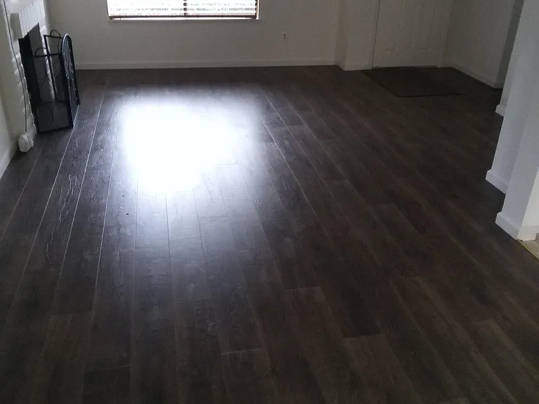 View of living room towards front door with beautiful Pergo Flooring.