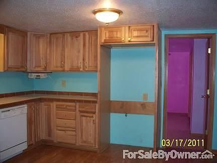 kitchen : view where refrigerator goes and door into bedroom #2