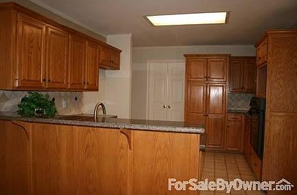 Kitchen
						:
						Granite countertops and tile backsplash with undercounter sink