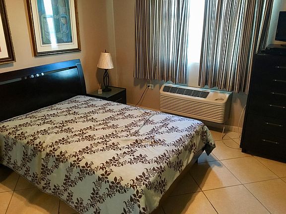 another queen bed with 2 night stands, tv and dresser