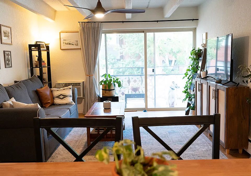 Living room receives plenty of natural light. Plants love the sliding glass door.