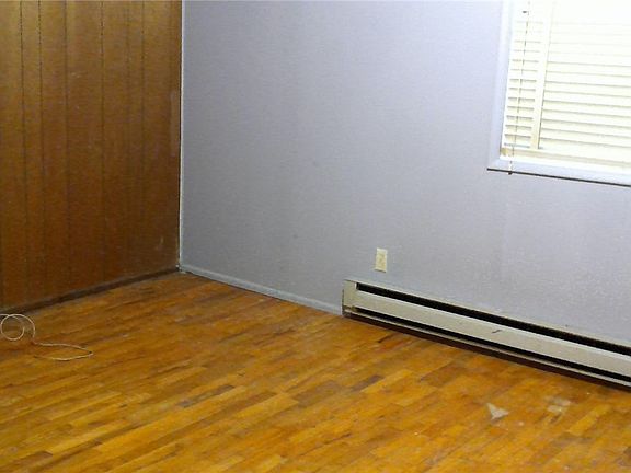 Tiny house bedroom is approx 12x11 with hardwood flooring