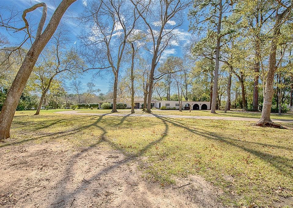 Fabulous four bedroom home with a pool that backs up to the bayou. This hidden gem sits on 2 acres and has beautiful trees and fantastic curb appeal.