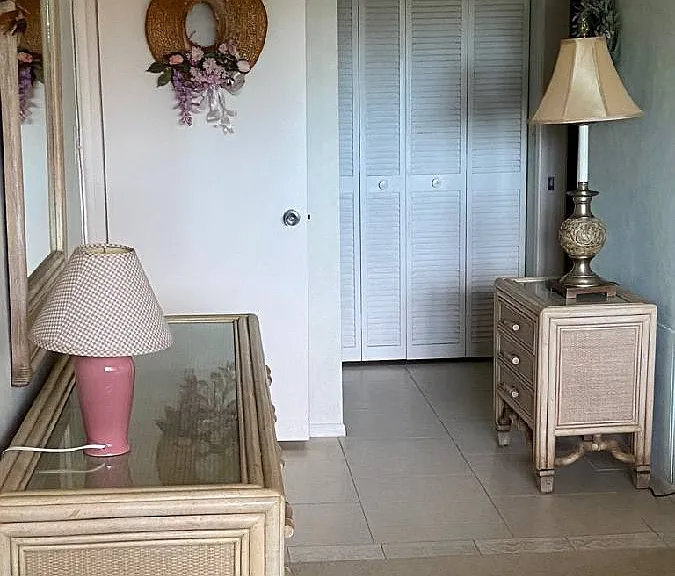 master bedroom door opens from hallway to living room. Tiled floor onto master bathroom.