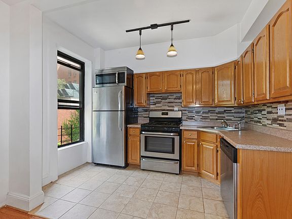 Kitchen with stainless appliances with dishwasher.