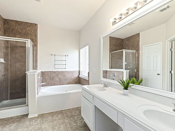 Double vanity anyone? This luxurious bathroom has standup shower and separate large tub!