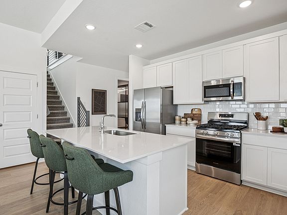 Kitchen in the Trinity home plan by Trophy Signature Homes - REPRESENTATIVE PHOTO