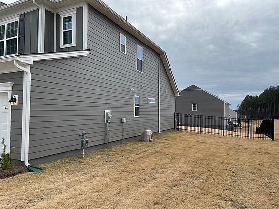 Bermuda Grass and side view entrance to the fenced in back yard