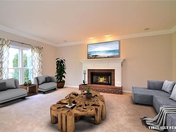 Family room with large windows and fireplace.