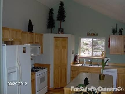 Kitchen
						:
						Hickory cabinets/flooring, high ceilings, stainless sink, tile counters, island