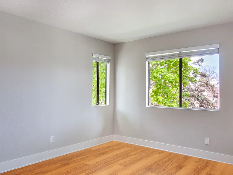 Spacious bedroom with wood flooring throughout