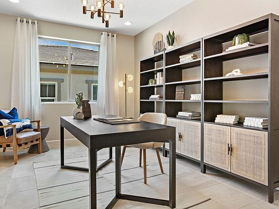 The functional Parklane den shown with stylish tile, tan paint, and a large window for ample natural