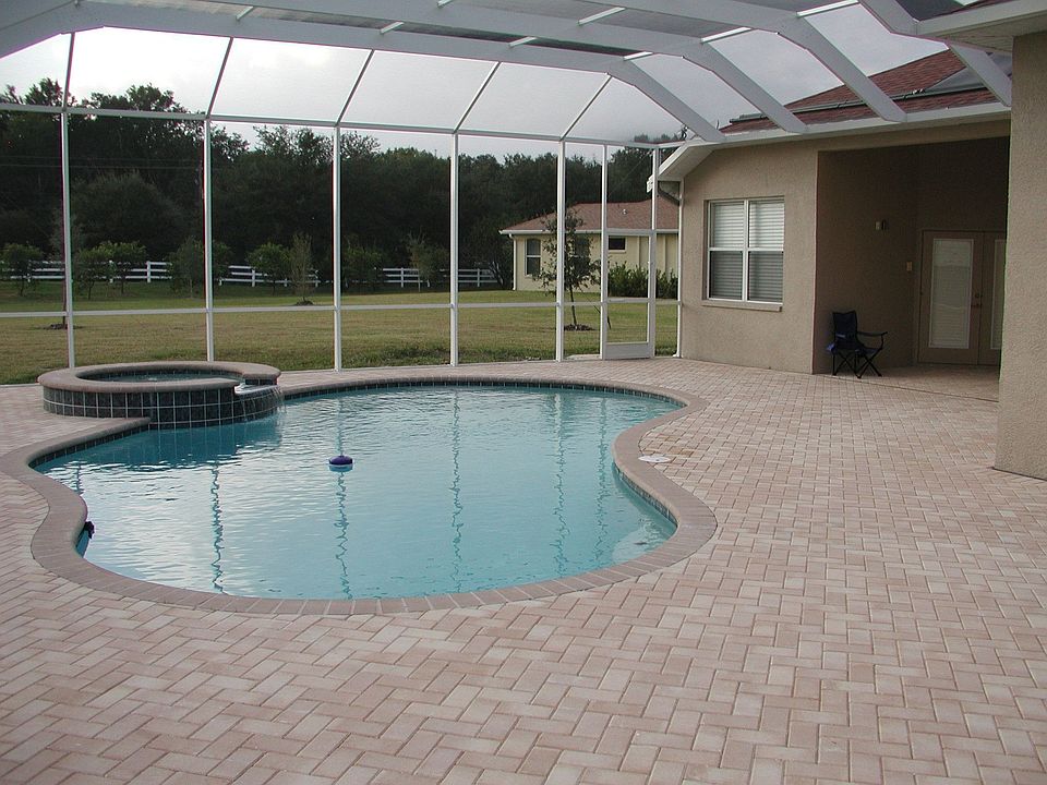 Large paved screened patio/pool