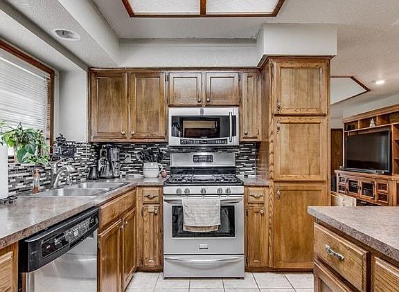 Kitchen has been updated with newly installed Formica countertops and glass backsplash.