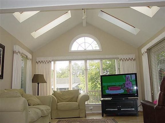 Family room w/vaulted ceiling, skylights, doorwall to deck