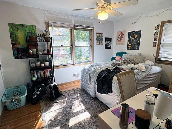 Main floor bedroom with ceiling fan.
