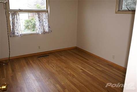 One of three bedrooms all with newly refinfised wood floors for easy cleaning.
