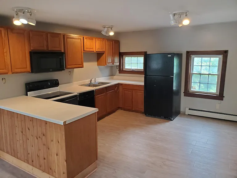 Kitchen with new over counter microwave unit.