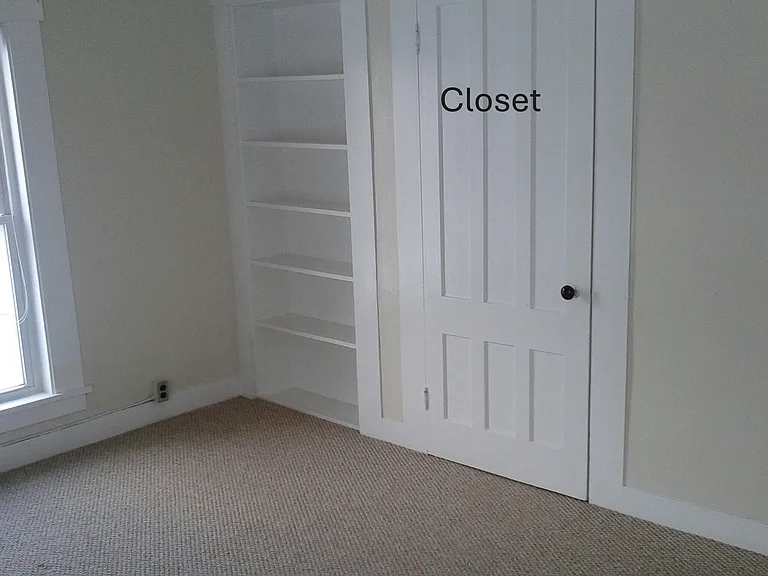 Another view of closet and shelves in main bedroom.