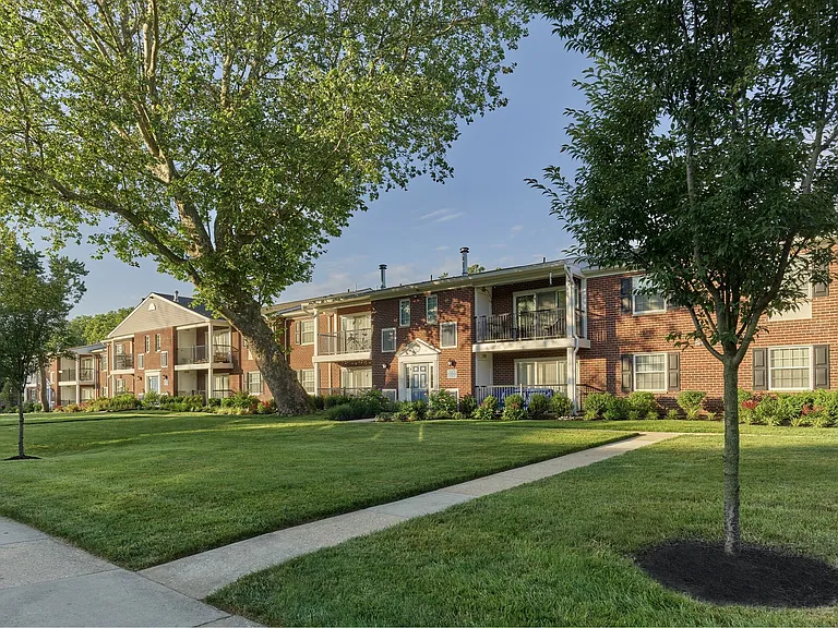 Discover lush green grass and mature trees at Delmont