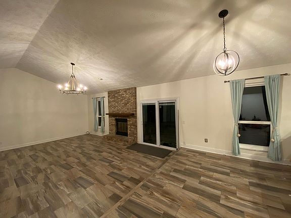 14' tall ceilings and extended living room with sliding glass door to screened in back patio