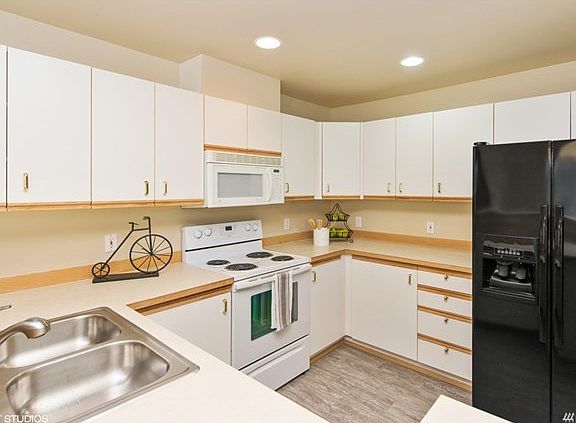 Large kitchen with plenty of storage & counter space. New flooring throughout