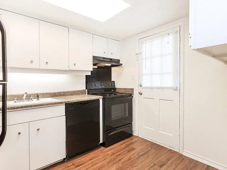 Fully equipped kitchen featuring updated cabinetry, appliances, and plenty of storage space.