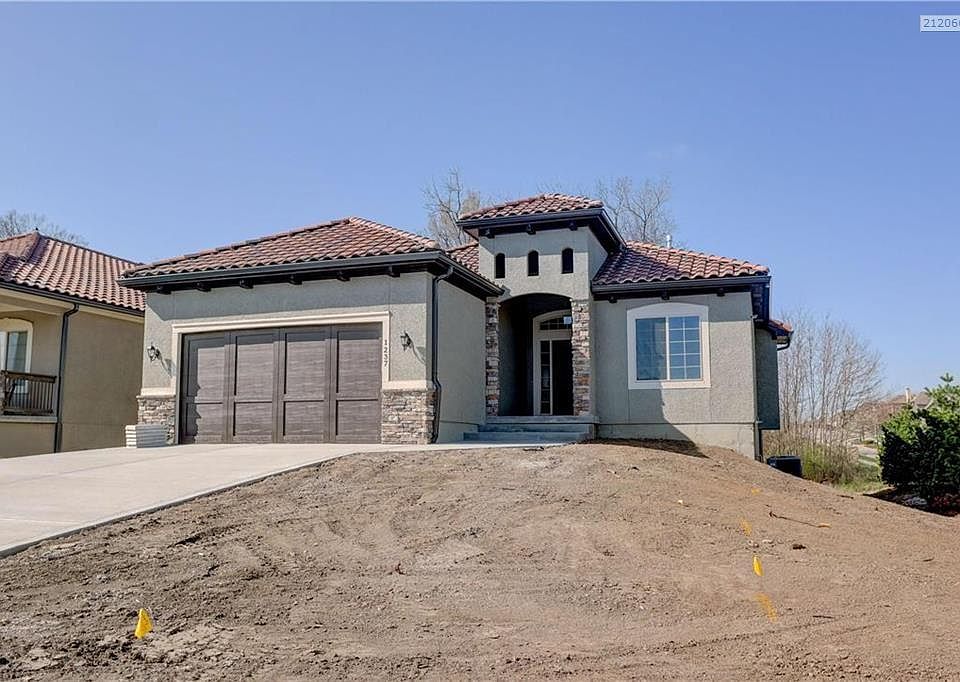 Ceramic tile roof by Crown Iberia and durable four-sided masonry stucco exterior. Cultured stone accents(per plan) with long las