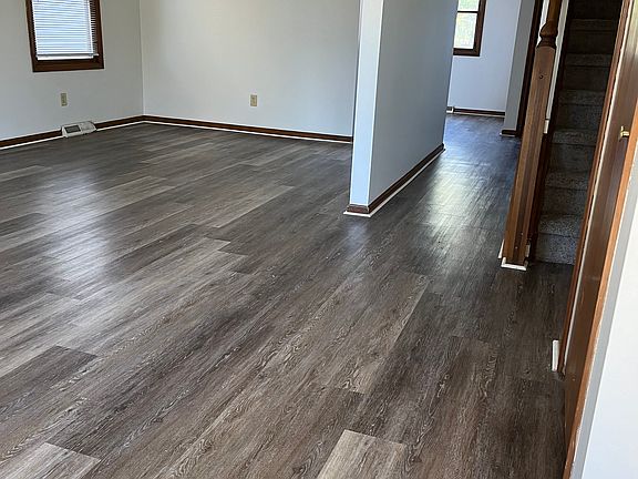 Luxury flooring in living room, dining room, kitchen, and baths