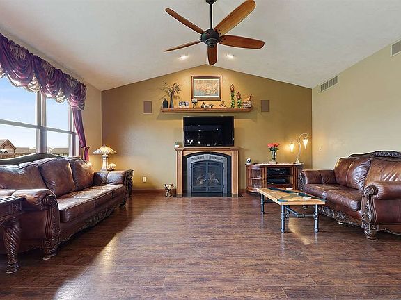 Kitchen/dining open to large living room with vaulted ceilings and gas fire place.