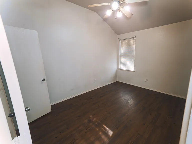A bright and airy bedroom offering ample floor space and a dedicated closet to keep your home organized