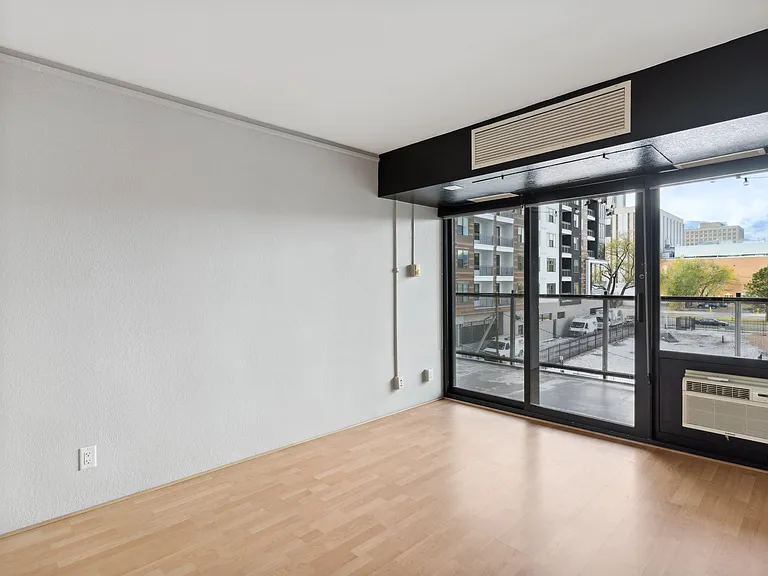 Bedroom 1 with balcony and custom walk-in closet.