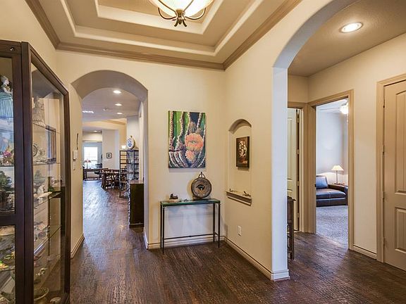 Wide front foyer with trey ceiling and hand scraped hardwoods.